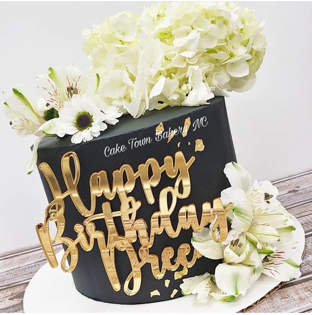 Black and white birthday cake with fresh flowers